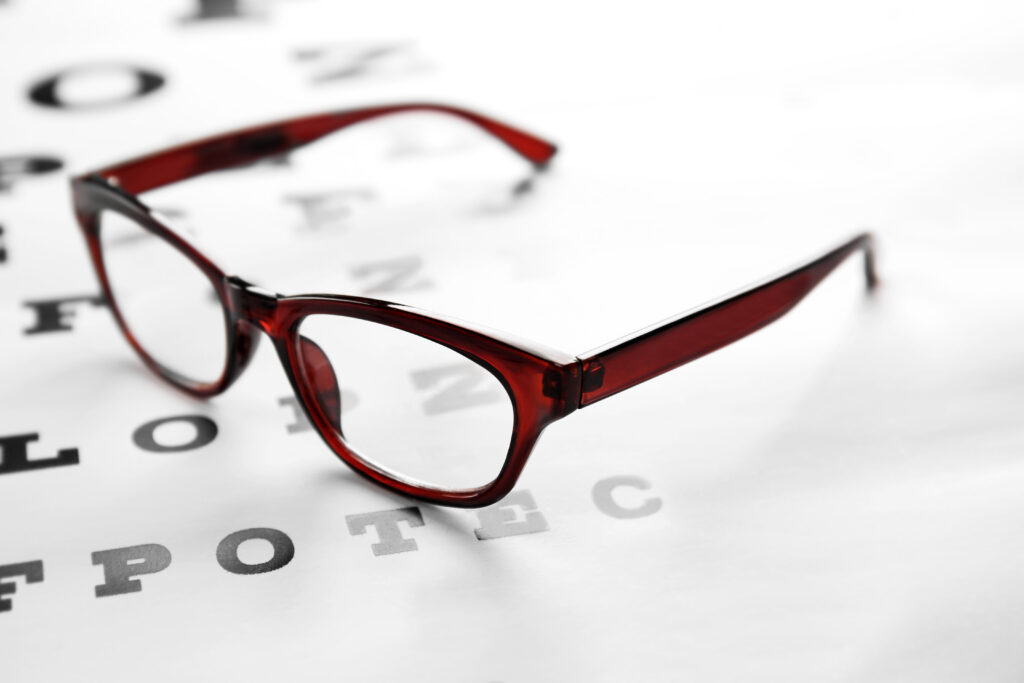 a pair of red glasses on an eye chart