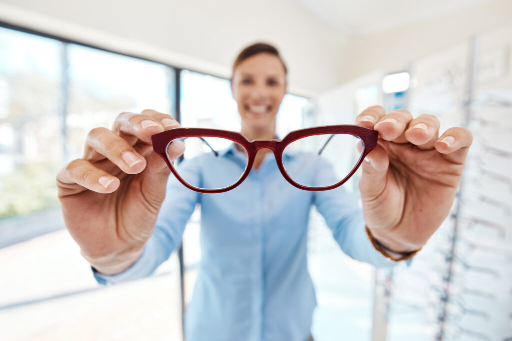 an optician holding glasses