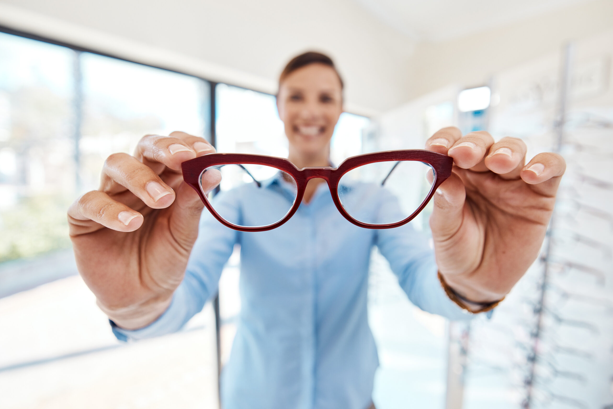 an optician holding glasses