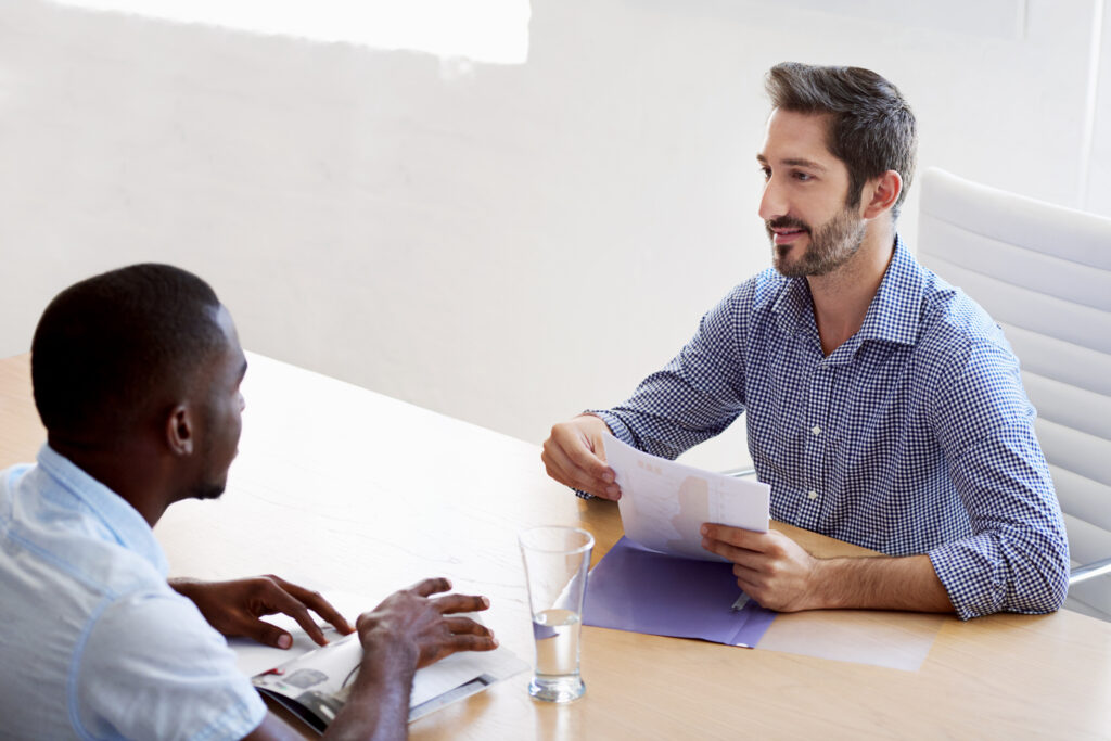 Meeting, documents and business men for interview, job vacancy and career opportunity. Corporate HR, recruitment and people in discussion, talking and conversation for hiring process in office.